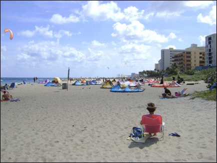 Beachgoers and windsurfers